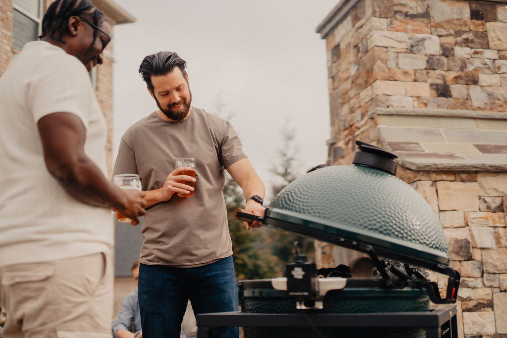 Men enjoying Rotisserie on open grill